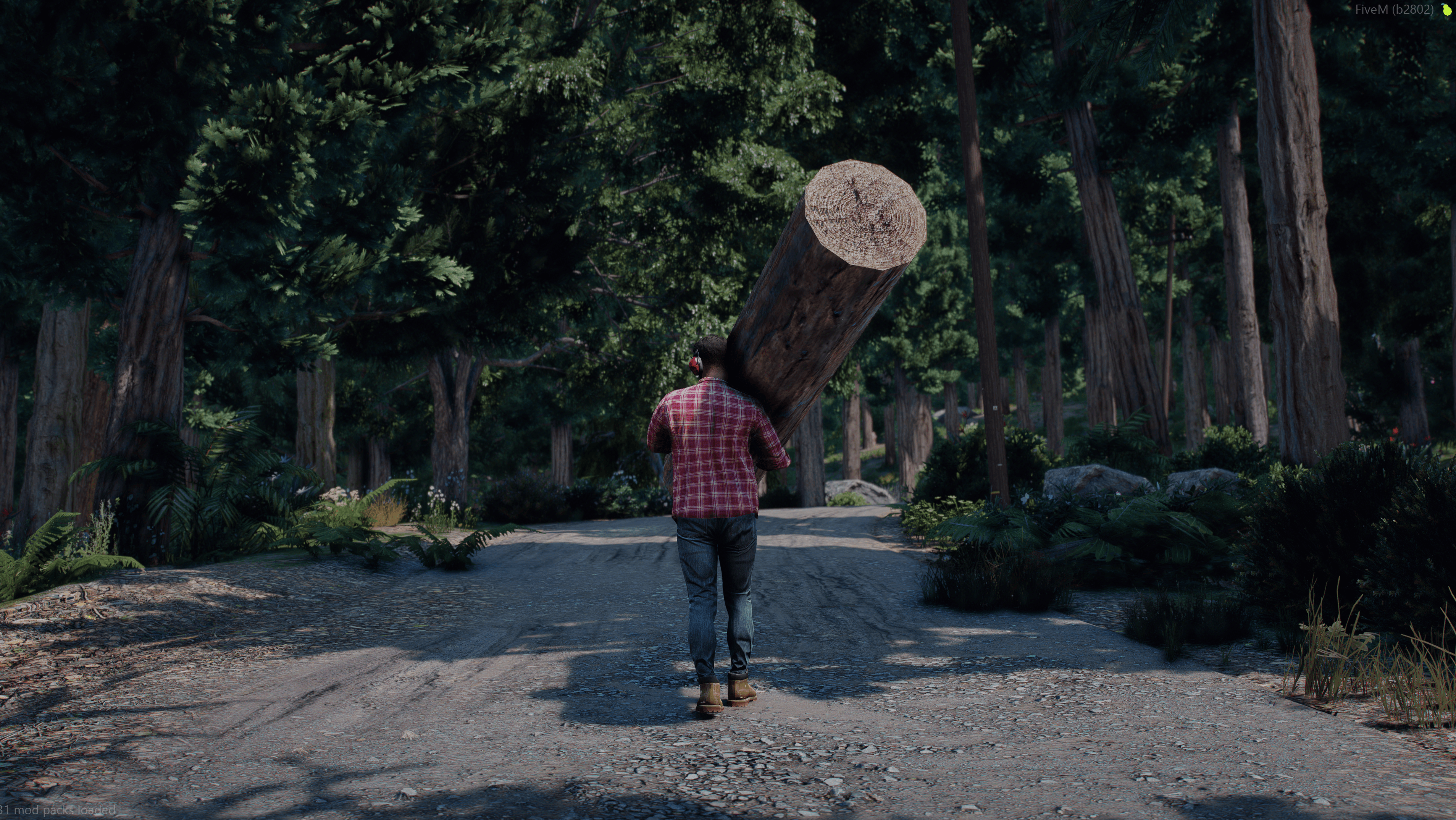Lumberjack carrying a log down a forest road